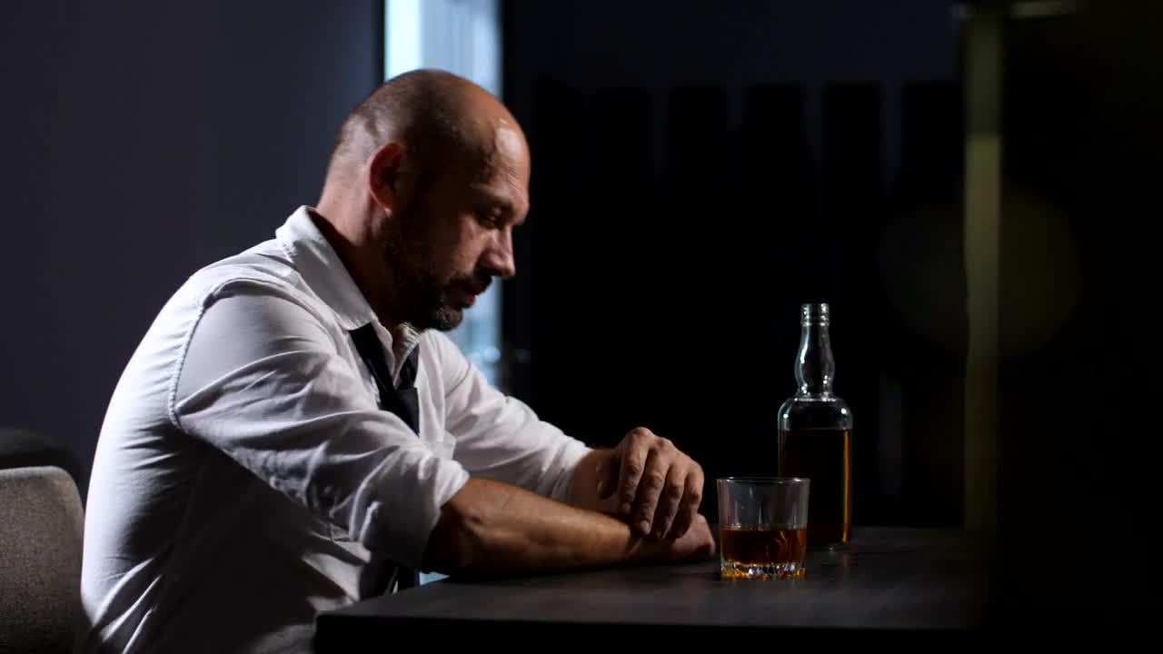 Stock Video Man Holding His Head At A Bar Animated Wallpaper