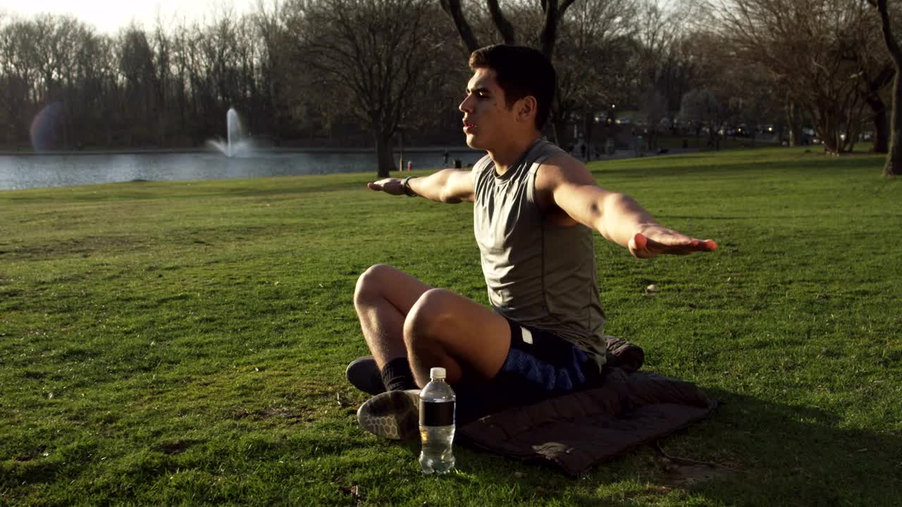 Stock Video Man Doing Yoga By A City Lake Animated Wallpaper