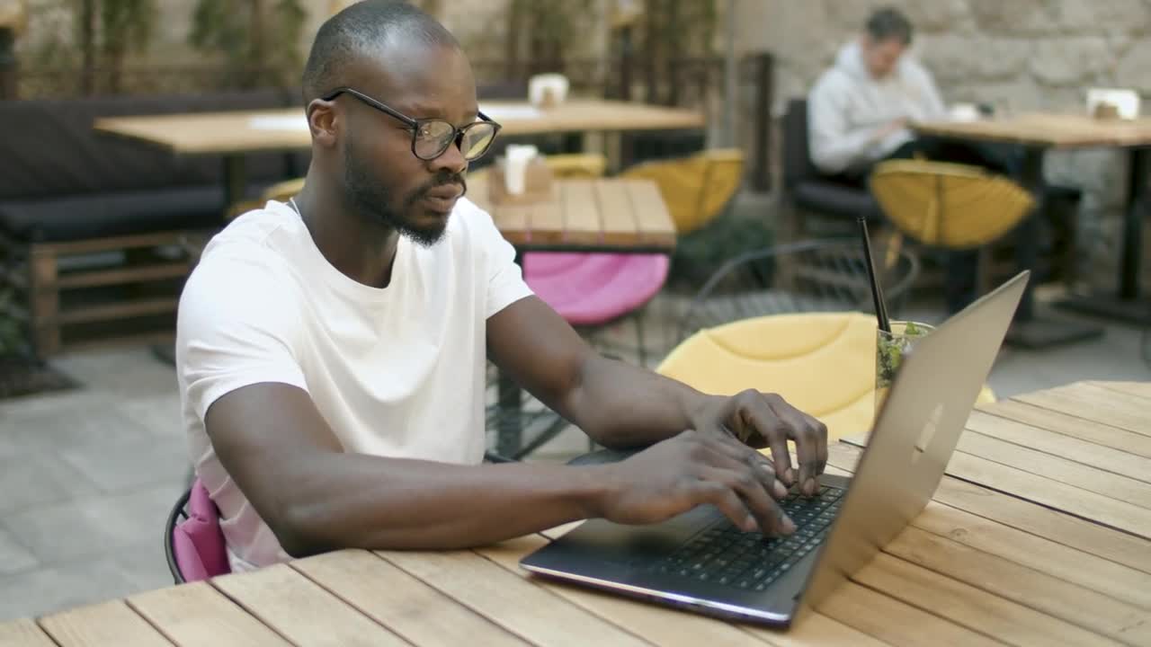 Stock Video Man Doing Online Research In Outdoor Cafe Animated Wallpaper