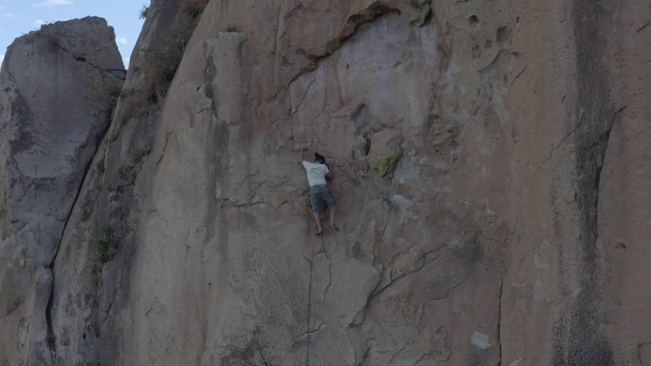 Stock Video Man Doing Mountaineering On A Large Rocky Mountain Animated Wallpaper