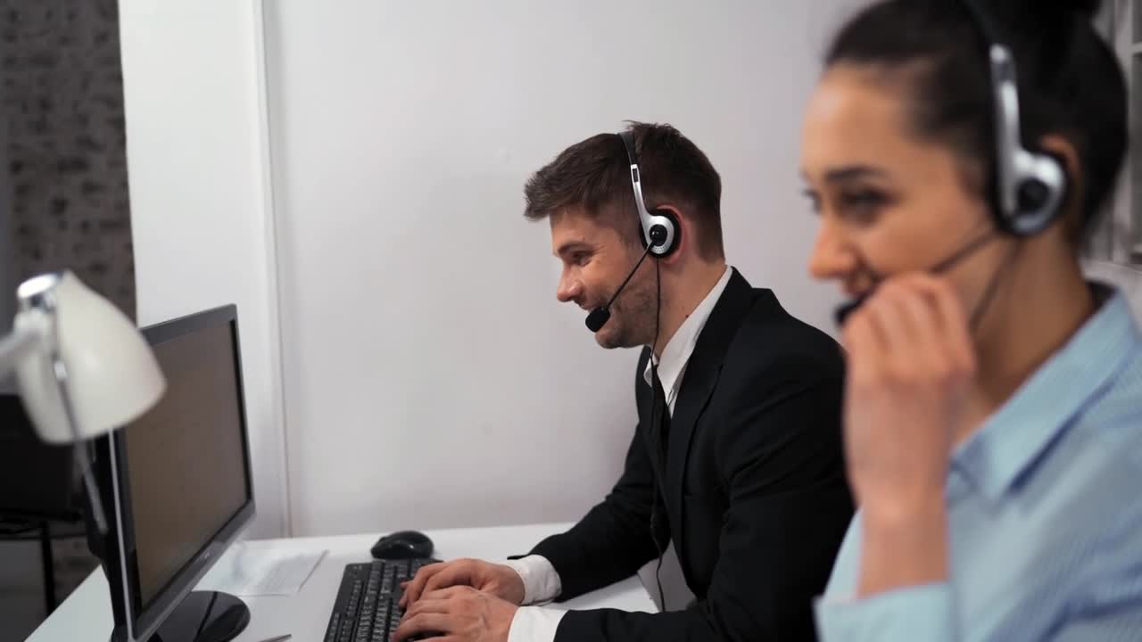 Stock Video Man And Woman Working In A Call Center Animated Wallpaper
