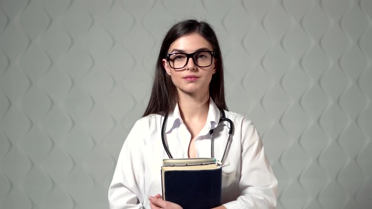 Stock Video Lovely Smiling Doctor Stands In Hospital Hallway Animated Wallpaper