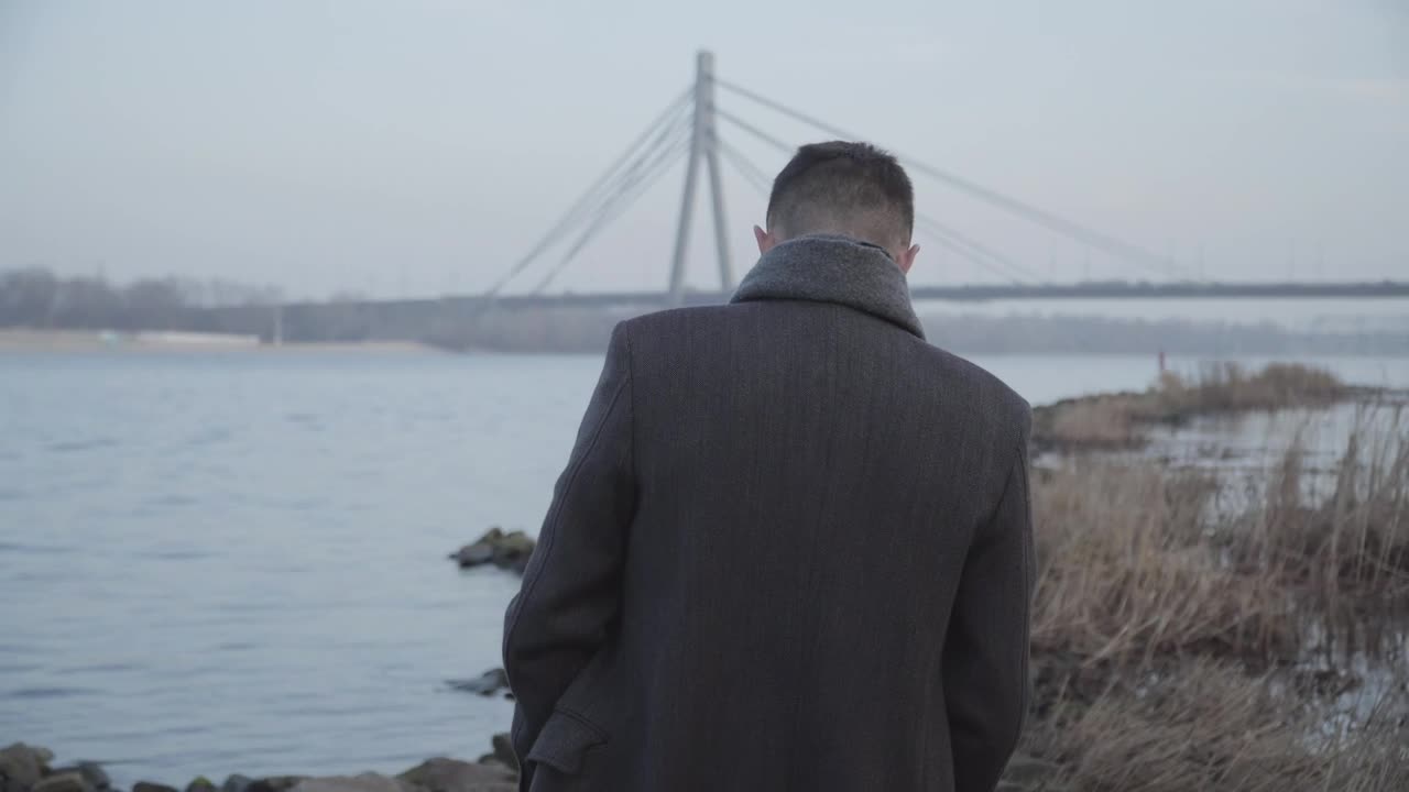 Stock Video Lonely Man Walking And Thinking Along Urban River Animated Wallpaper