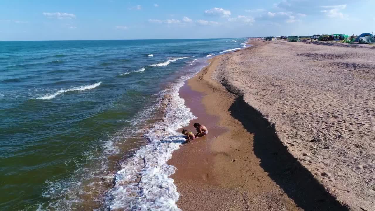 Stock Video Little Girls Play In The Sand With The Waves Of Animated Wallpaper