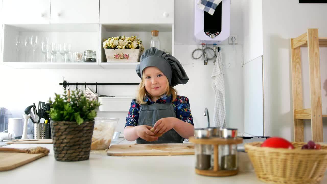 Stock Video Little Girl In A Kitchen Making Cookies With Dough Animated Wallpaper
