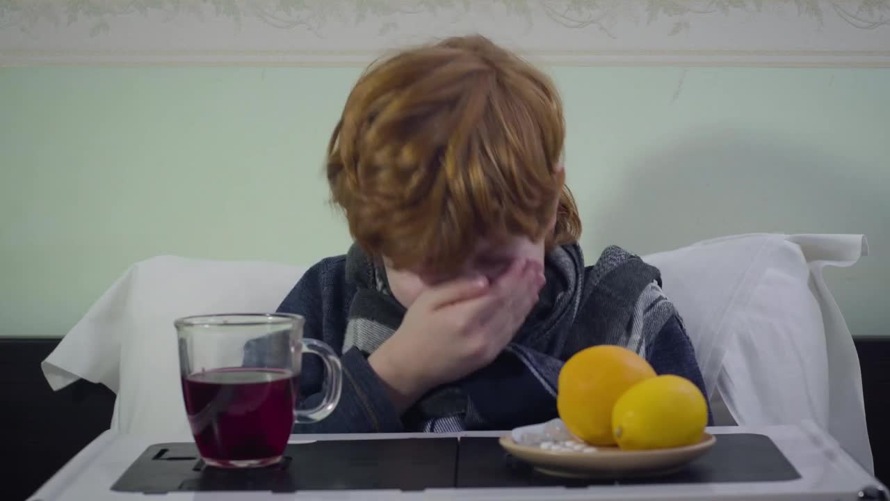 Stock Video Little Boy Sneezes While Sick In Bed With Breakfast Animated Wallpaper