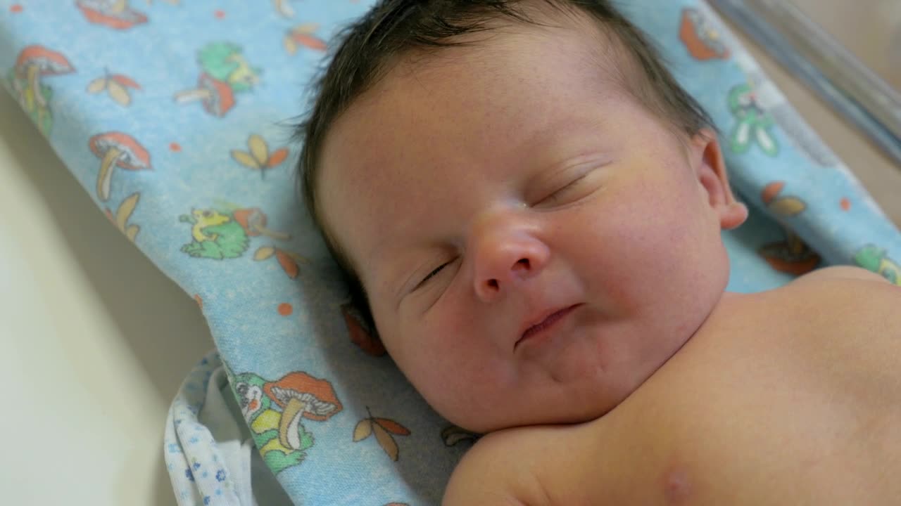 Stock Video Lifting A Baby From A Mat Animated Wallpaper