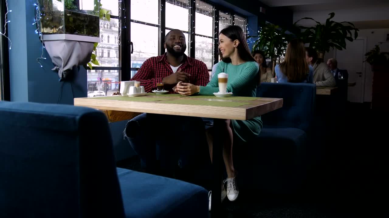 Stock Video Laughing Couple In A Coffee Shop Animated Wallpaper