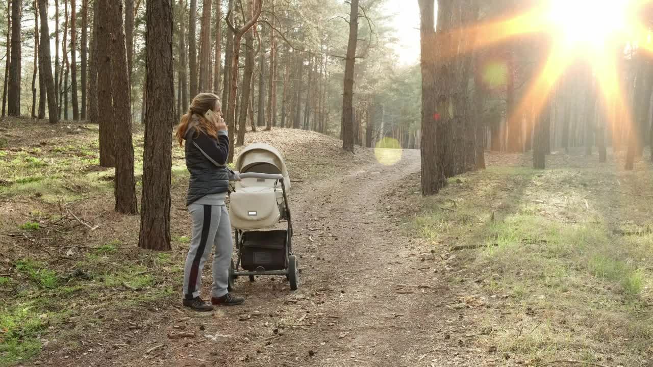 Stock Video Mother Talking On The Phone At Wood Animated Wallpaper