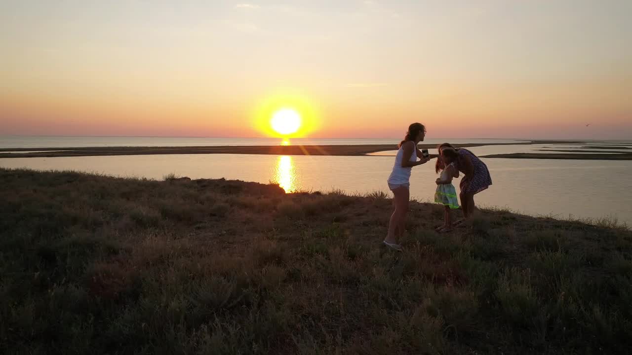 Stock Video Mother Taking Photos Of Her Daughters In Natur Animated Wallpaper