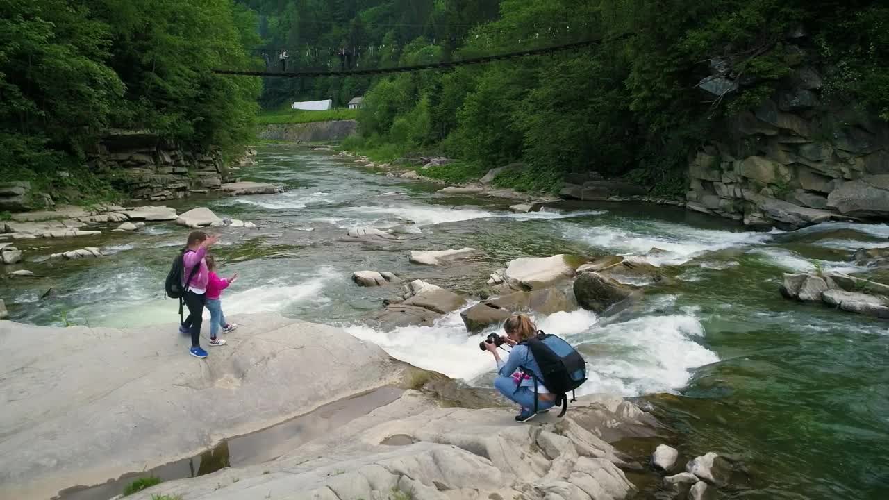 Stock Video Mother Taking Photos Of Her Daughters In A Rive Animated Wallpaper