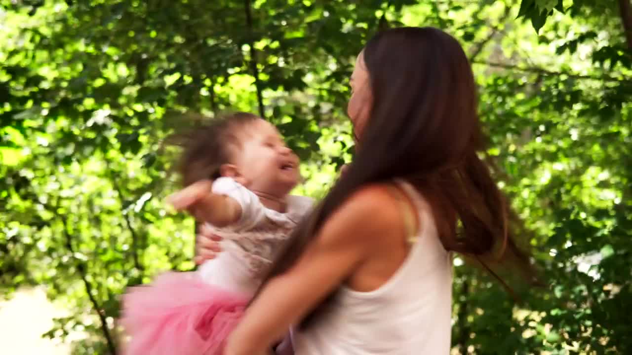 Stock Video Mother Spinning Her Child In The Garde Animated Wallpaper