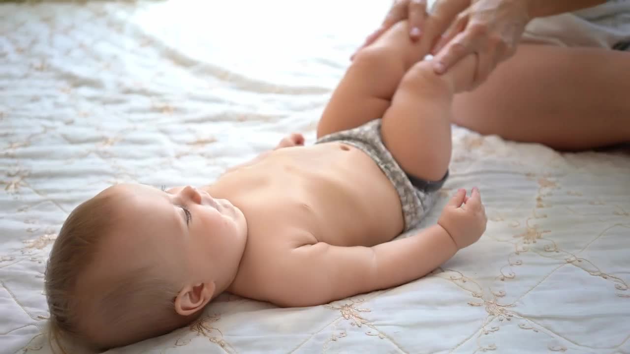 Stock Video Mother Exercising Her Babys Leg Animated Wallpaper