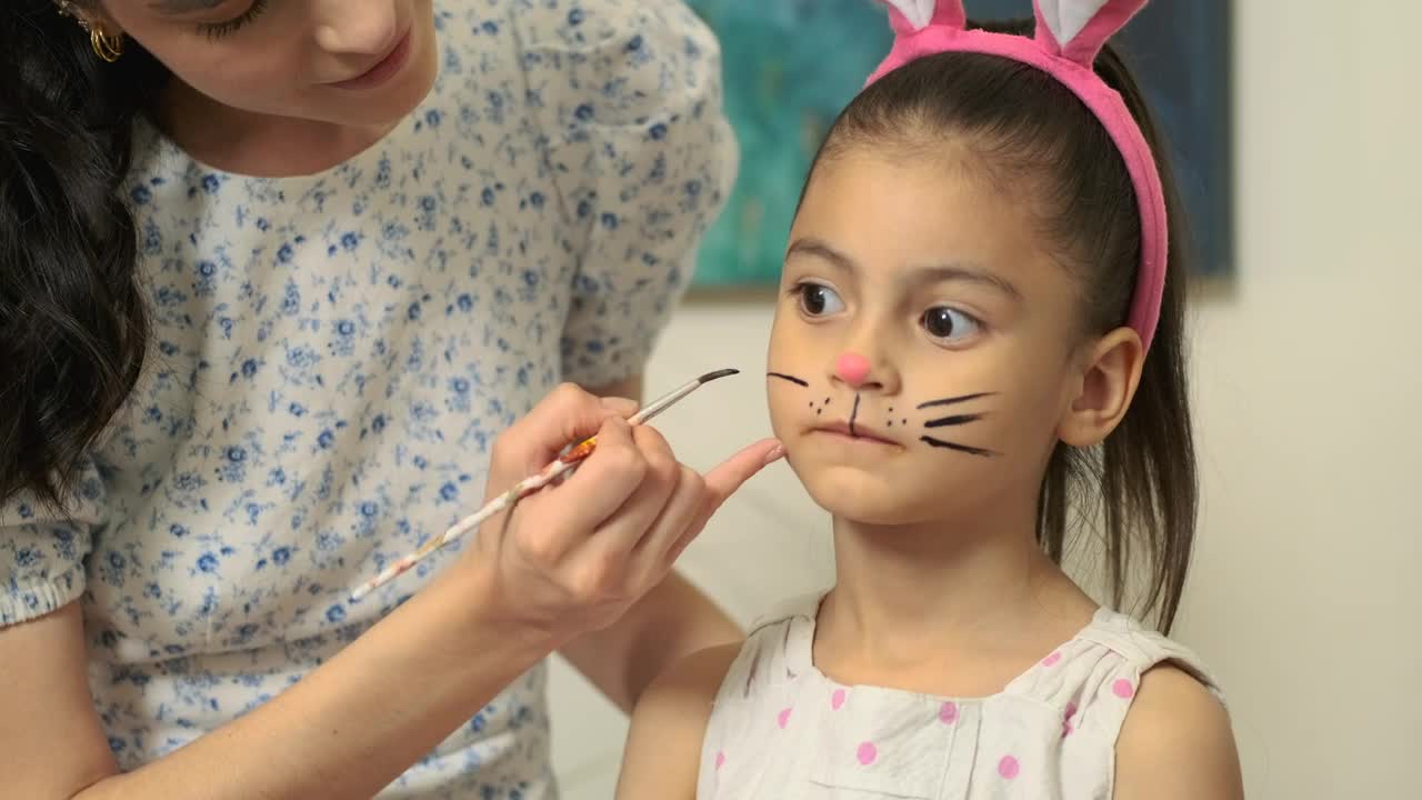 Stock Video Mother Draws Rabbit Whiskers To Her Daughte Animated Wallpaper