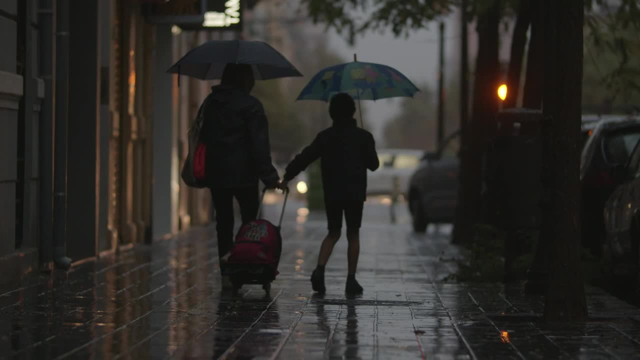 Stock Video Mother And Son Walking In The Rai Animated Wallpaper
