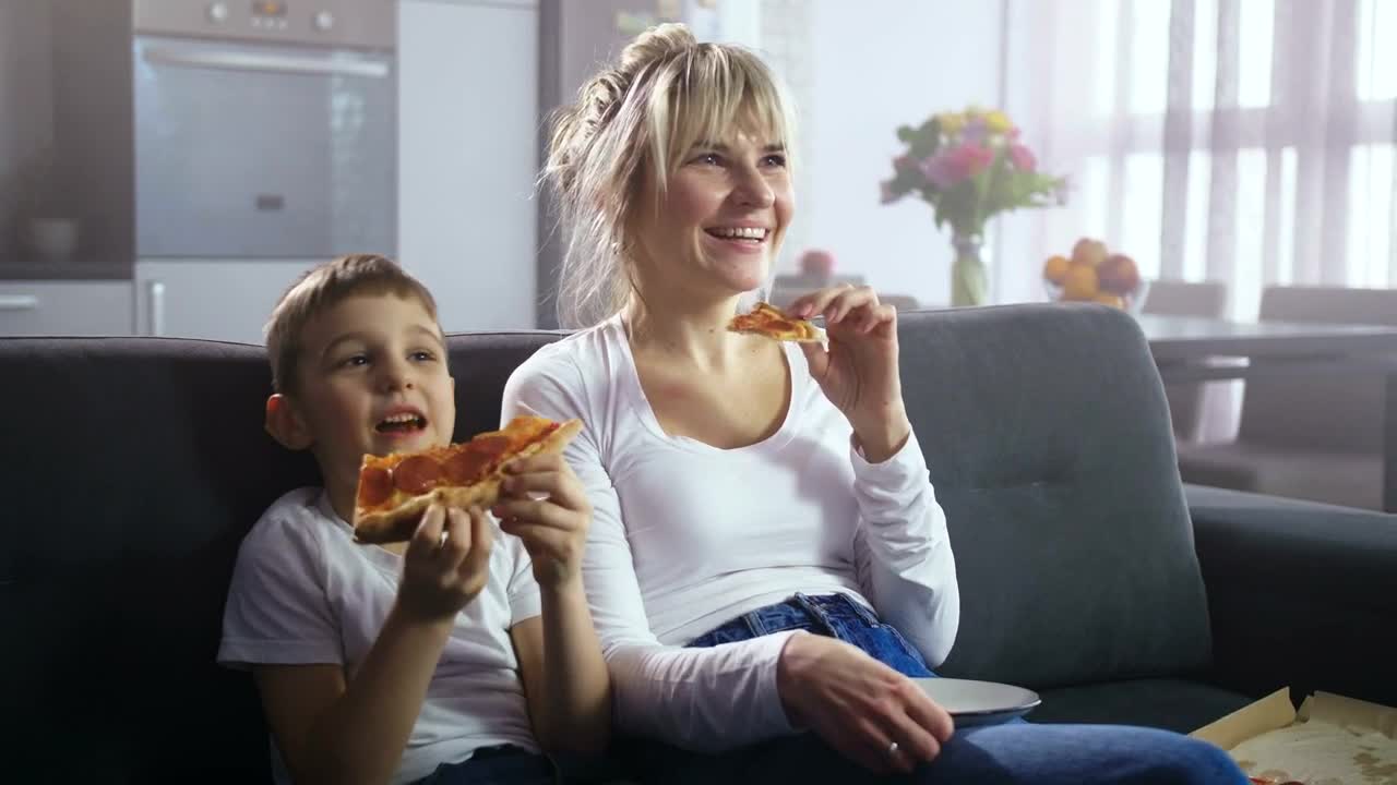 Stock Video Mother And Son Eating Pizz Animated Wallpaper