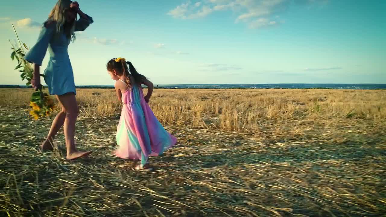 Stock Video Mother And Daughter Play Happily In A Dry Fiel Animated Wallpaper