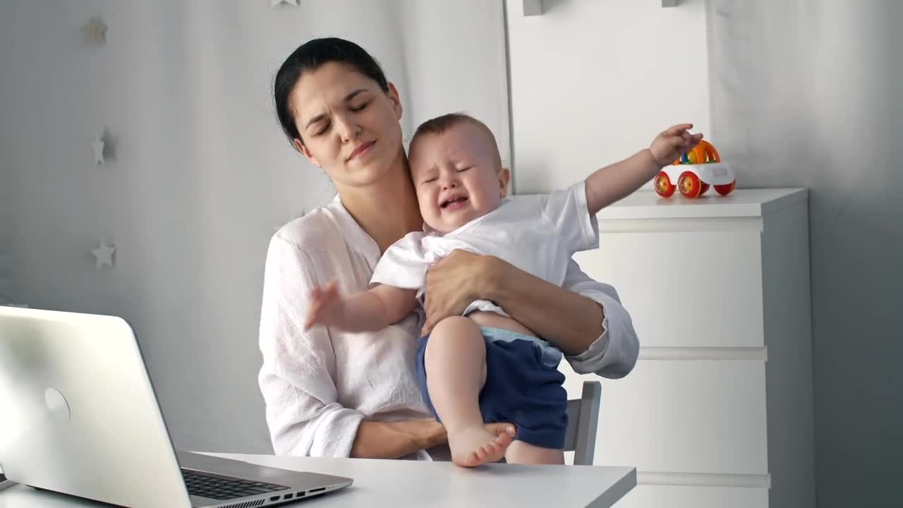 Stock Video Mom Tries To Work From Home Taking Care Of Animated Wallpaper