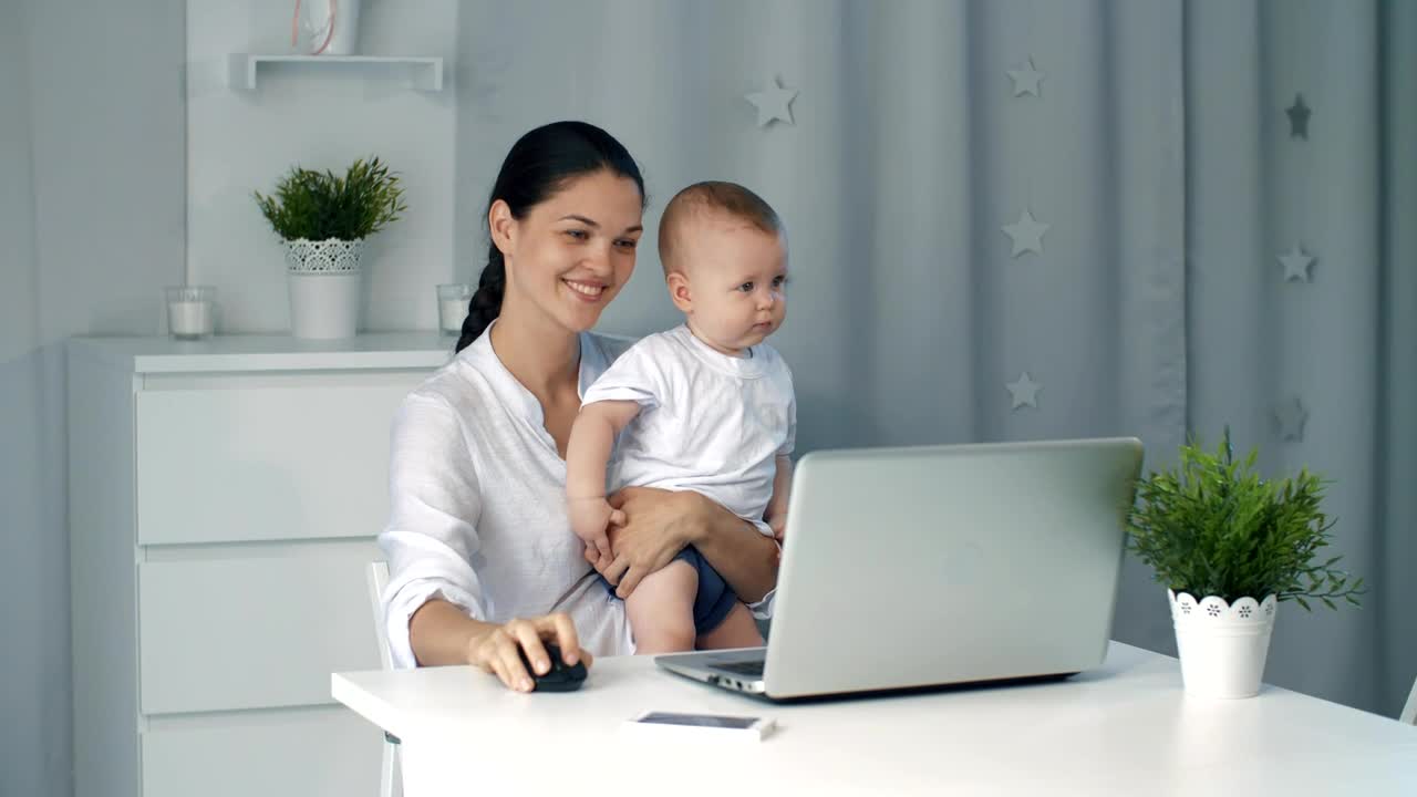 Stock Video Mom On Her Computer While Taking Care Of Her So Animated Wallpaper