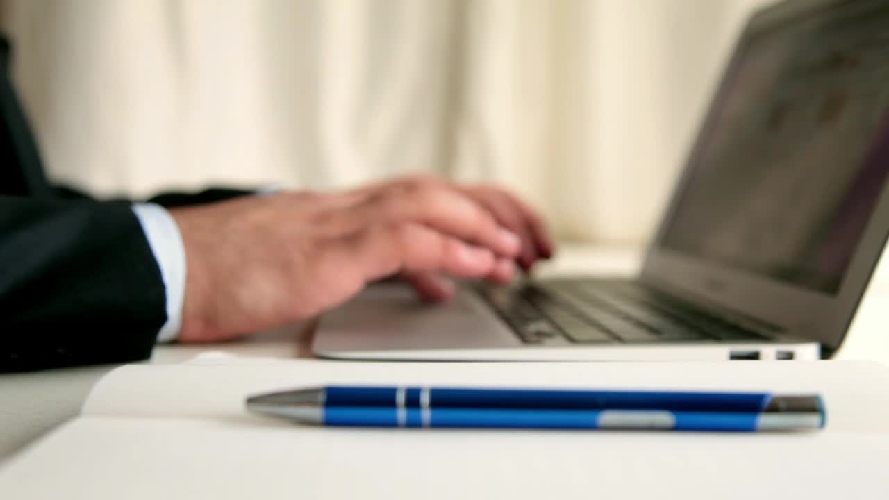 Stock Video Men Taking Note While Browsing In A Lapto Animated Wallpaper