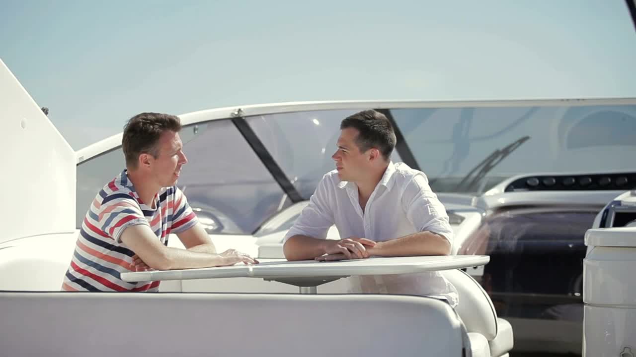 Stock Video Men Discuss Business Sale On Deck Of Yach Animated Wallpaper