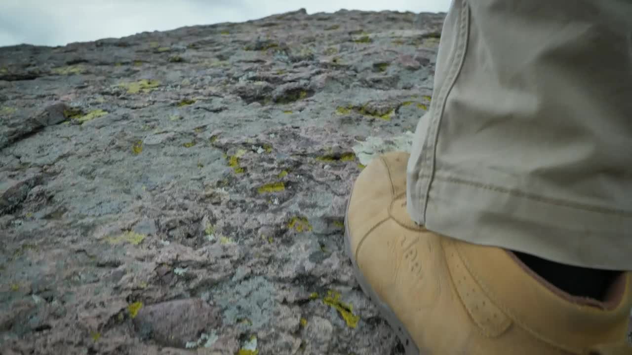 Stock Video Man With Yellow Boots Walking On A Ston Animated Wallpaper