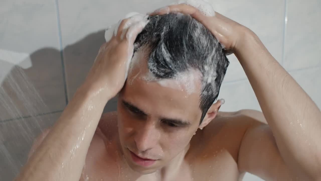 Stock Video Man Washing Hair In Showe Animated Wallpaper