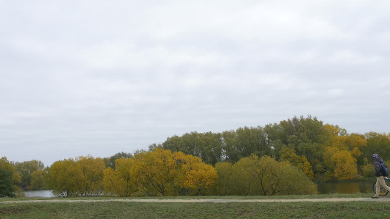 Stock Video Man Walking Through The Countryside With His Bik Animated Wallpaper