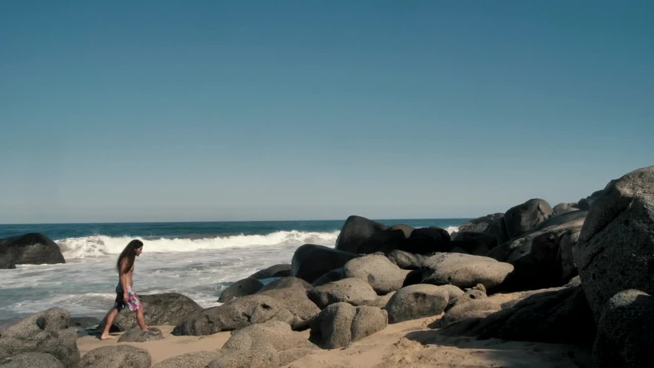 Stock Video Man Walking On Large Boulder Animated Wallpaper