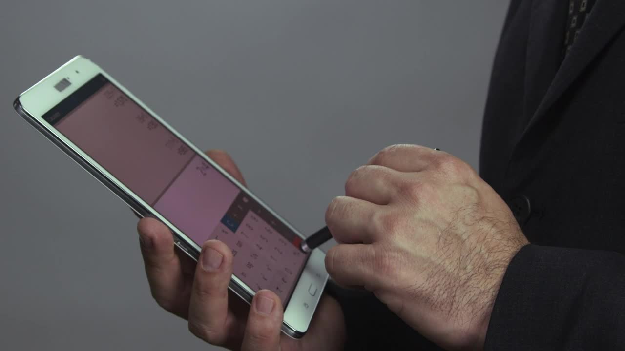 Stock Video Man Using A Tax Calculato Animated Wallpaper