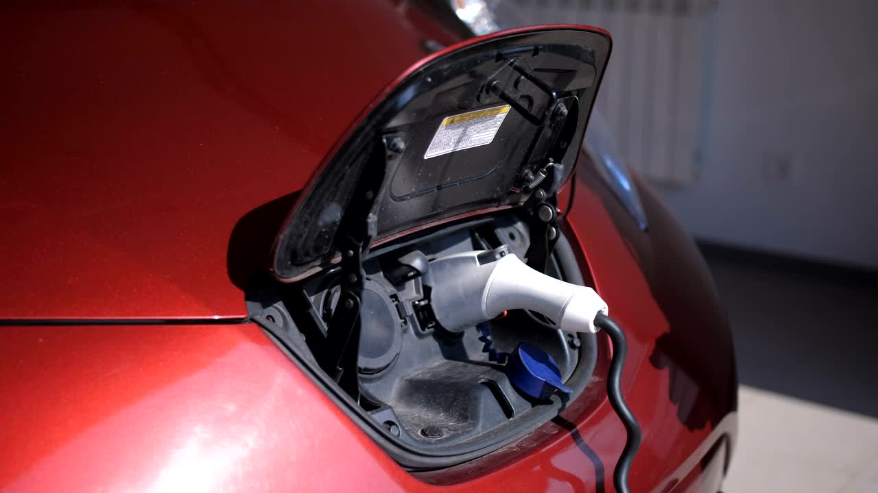 Stock Video Man Unplugging His Car From A Charging Ba Animated Wallpaper
