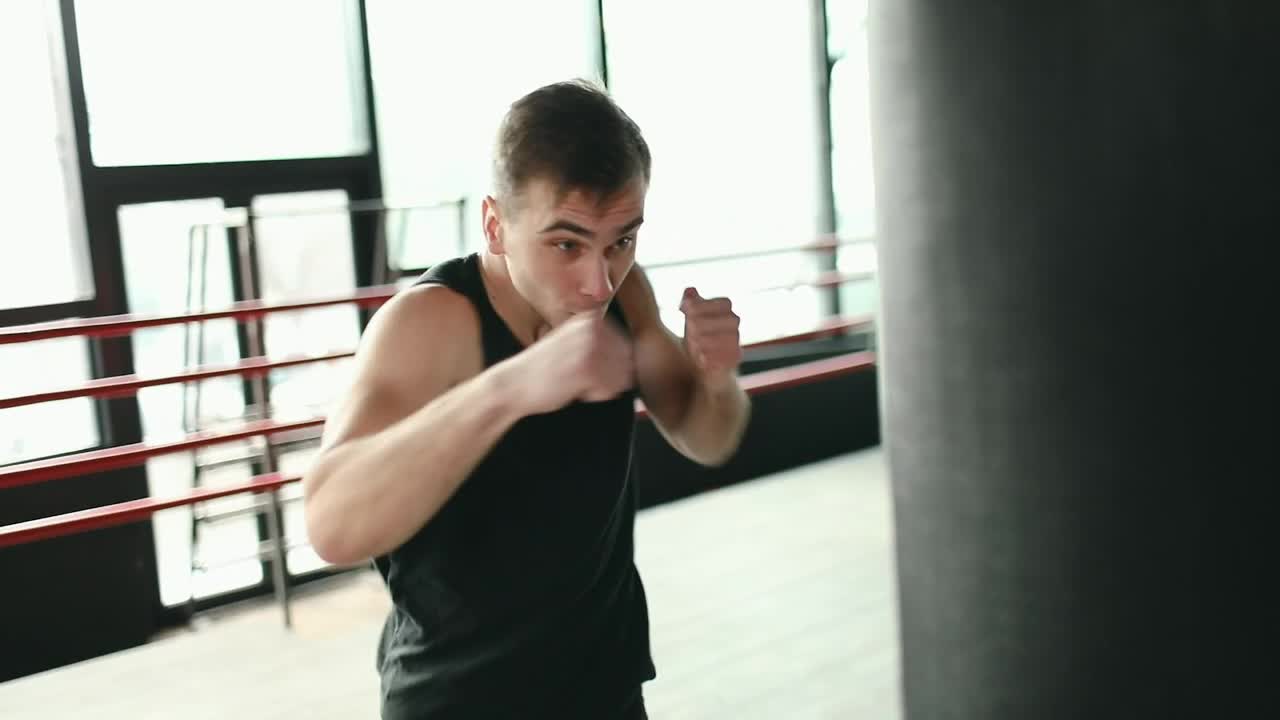 Stock Video Man Training On Punching Bag In Boxing Rin Animated Wallpaper