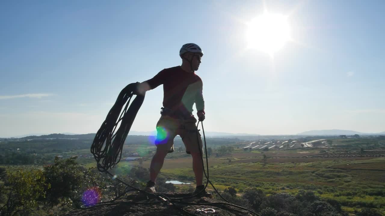 Stock Video Man Throwing A Rope From The Top Of A Hil Animated Wallpaper