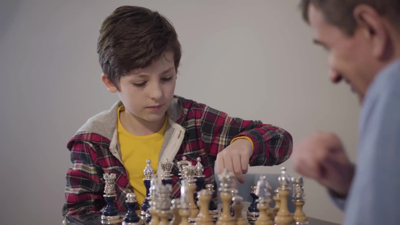 Stock Video Man Teaches Young Boy How To Win At Ches Animated Wallpaper