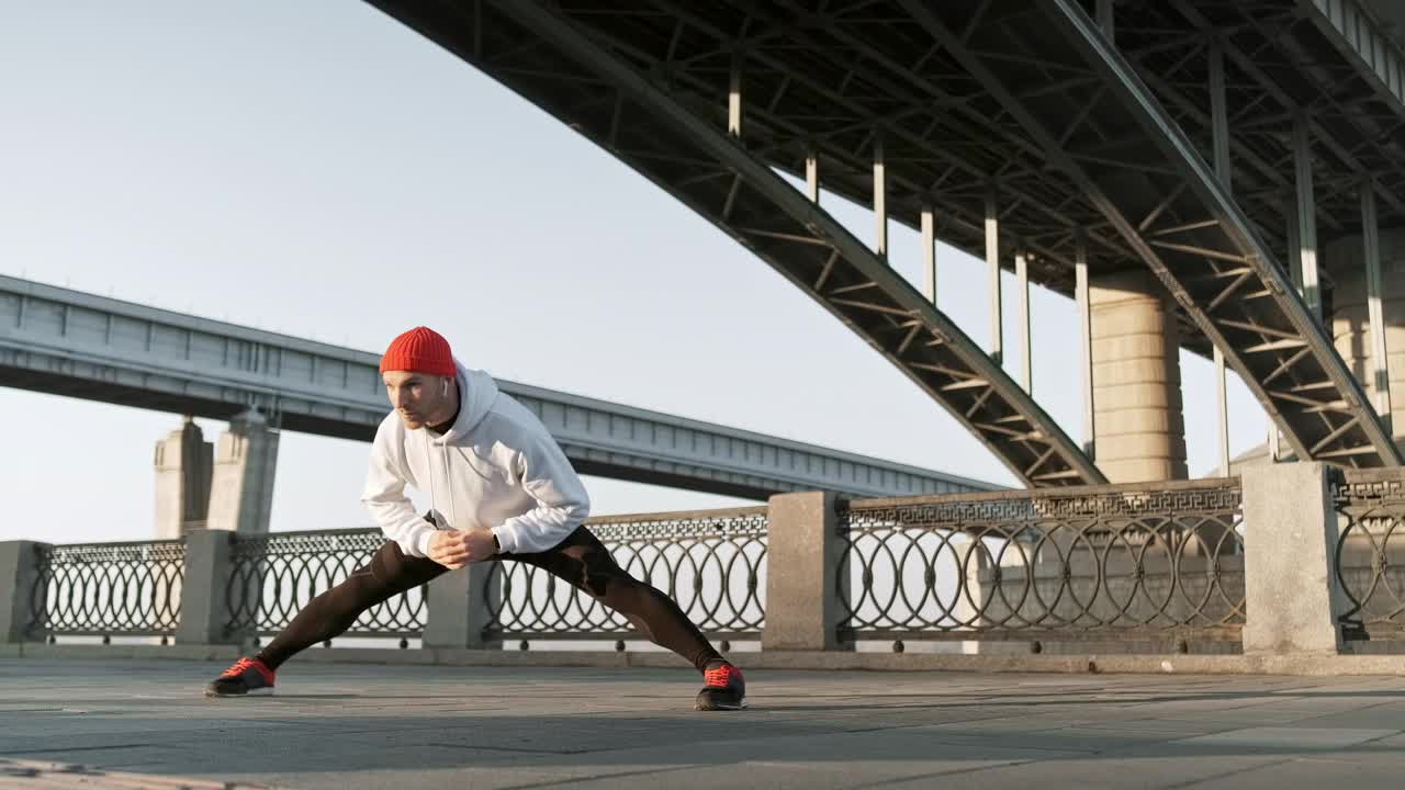 Stock Video Man Stretching His Body Before An Urban Workou Animated Wallpaper
