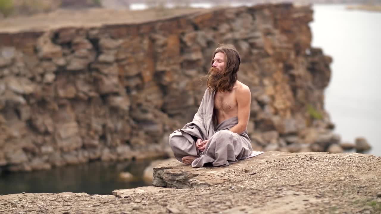 Stock Video Man Meditating On The Hill By The Se Animated Wallpaper