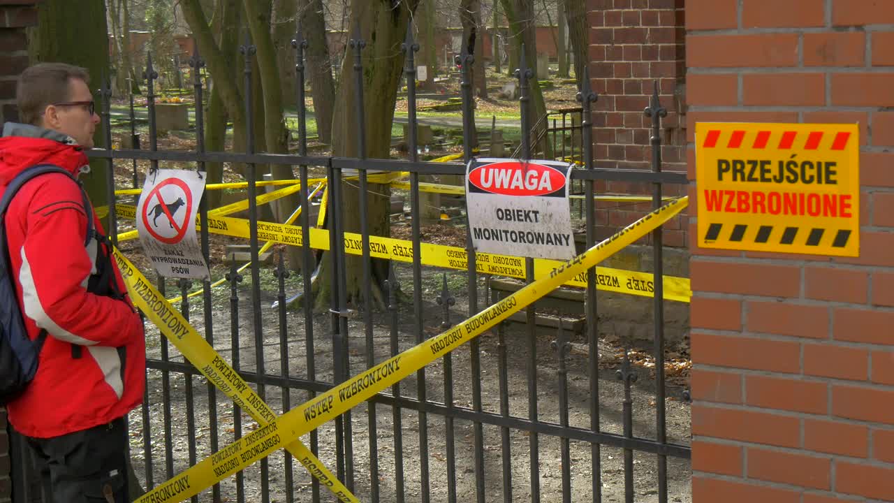 Stock Video Man Looking At A Closed Fence With Warning Sign Animated Wallpaper