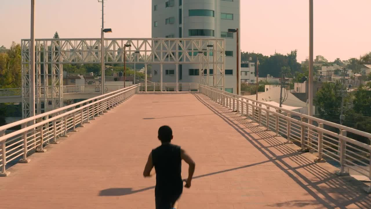Stock Video Man Jogging On A Pedestrian Bridge In The Cit Animated Wallpaper