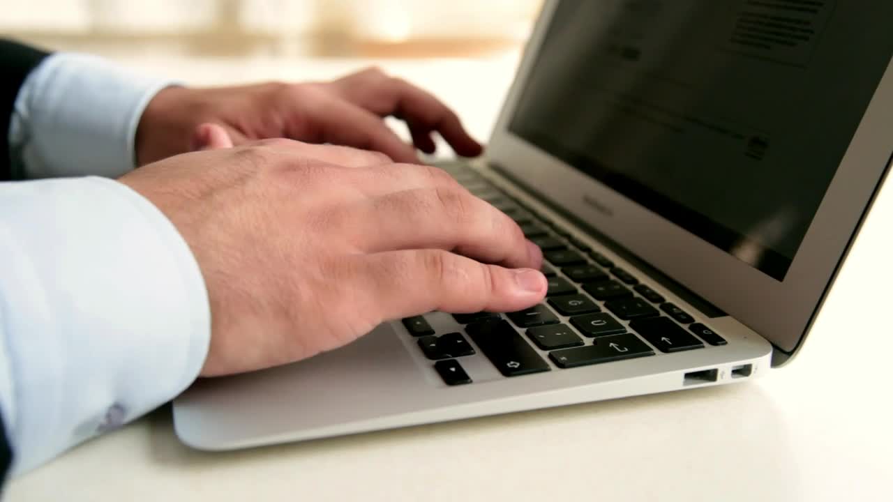 Stock Video Man In Suit Typing On A Lapto Animated Wallpaper