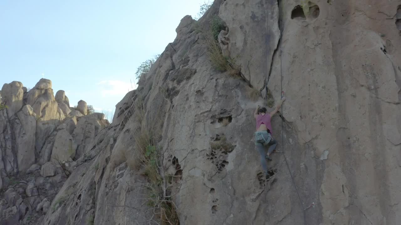 Stock Video Mountaineer Girl Climbing A Steep Rocky Mountain Live Wallpaper