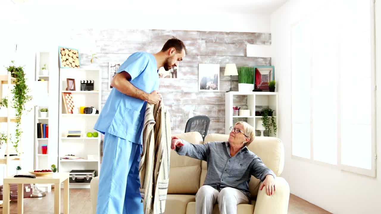 Stock Video Nurse Helps Elderly Woman Stand Up And Walk Live Wallpaper