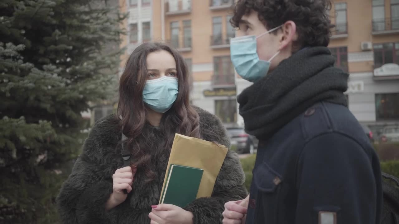 Stock Video Pair Of Boys With Masks Talking On The Street Live Wallpaper