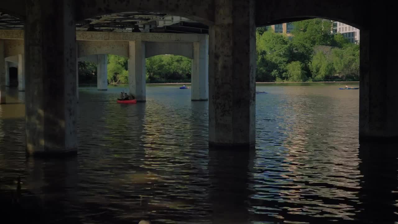 Stock Video People Rowing In A River Under A Large Bridge LargeLive Wallpaper
