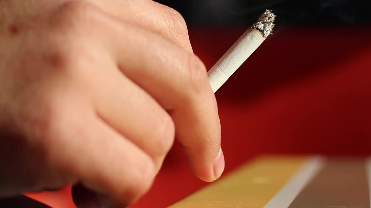 Stock Video Person Holding A Cigarette Live Wallpaper