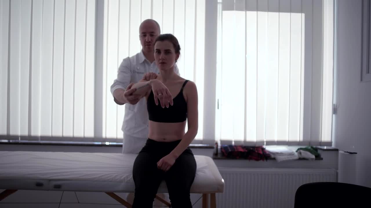 Video Stock Physician Moves Arm Of Female Patient Live Wallpaper Free