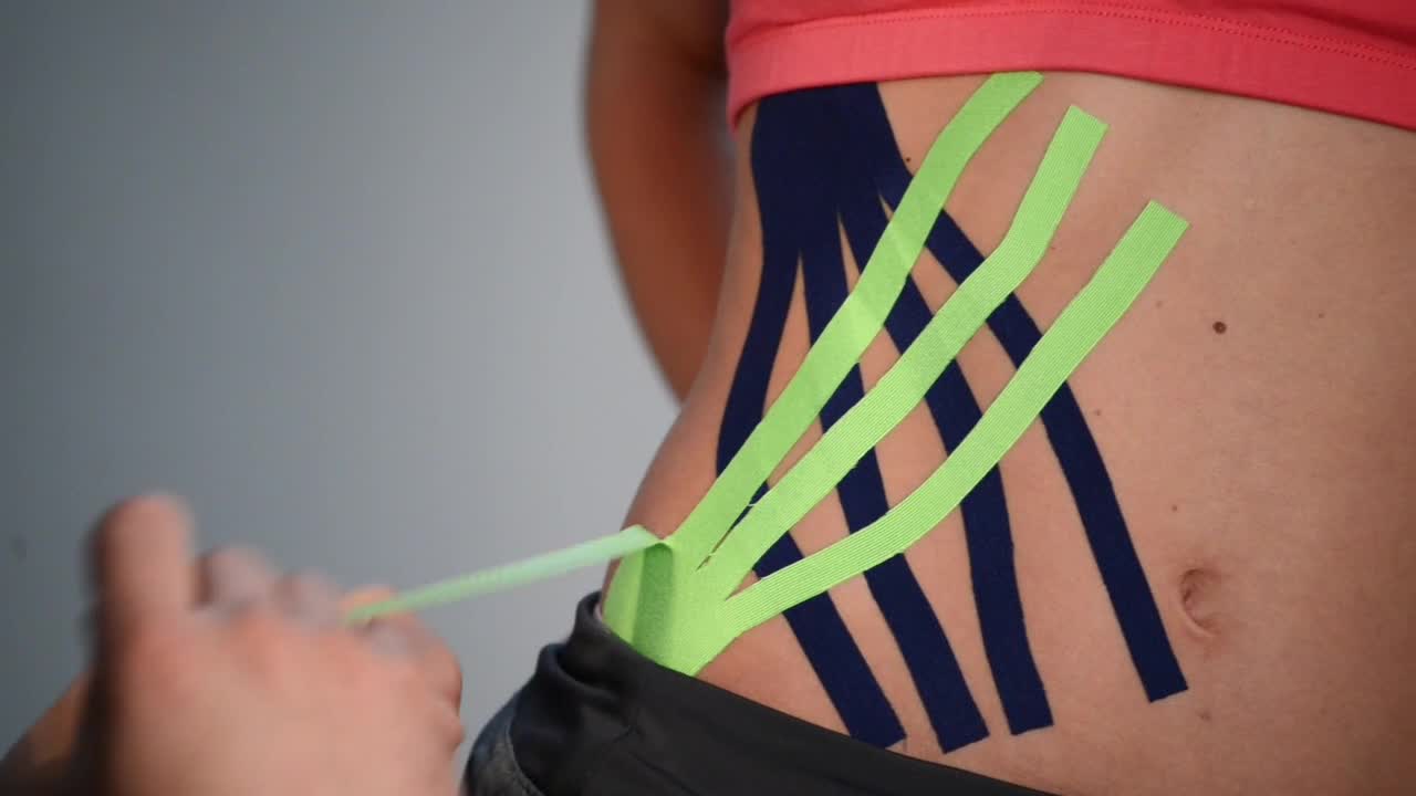 Video Stock Putting Kinesio Tape On An Athletes Hip Live Wallpaper Free