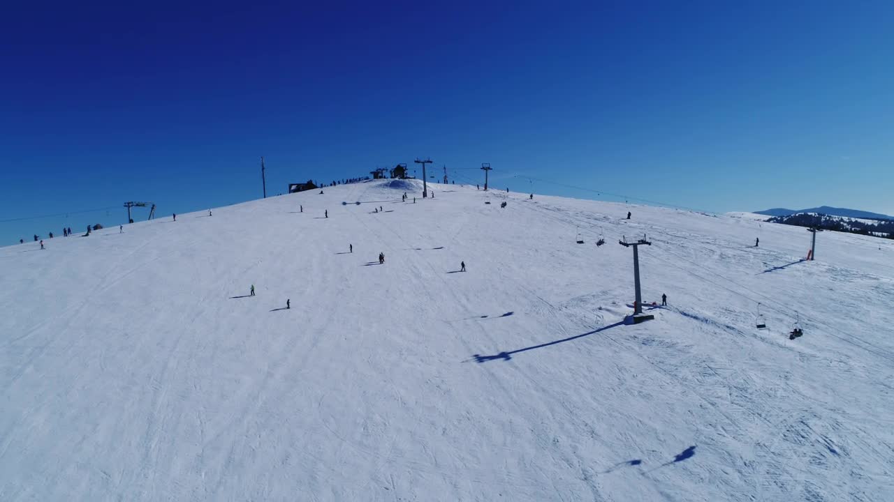 Free Video Stock Skiers On A Practice Mountain Aerial View Live Wallpaper