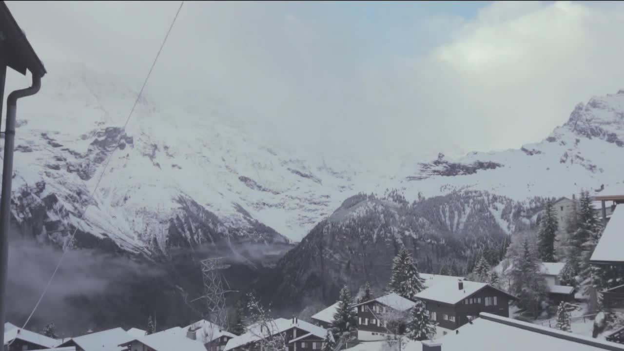 Free Video Stock Snowy Mountains Above A Small Town Live Wallpaper