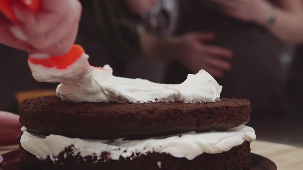 Free Video Stock Spreading Cream On A Chocolate Cake Live Wallpaper