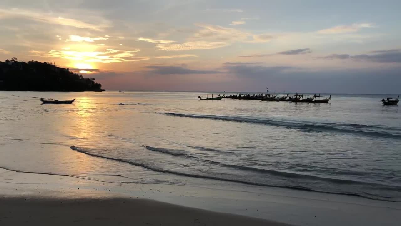 Free Video Stock sunset at a calm beach with boats Live Wallpaper